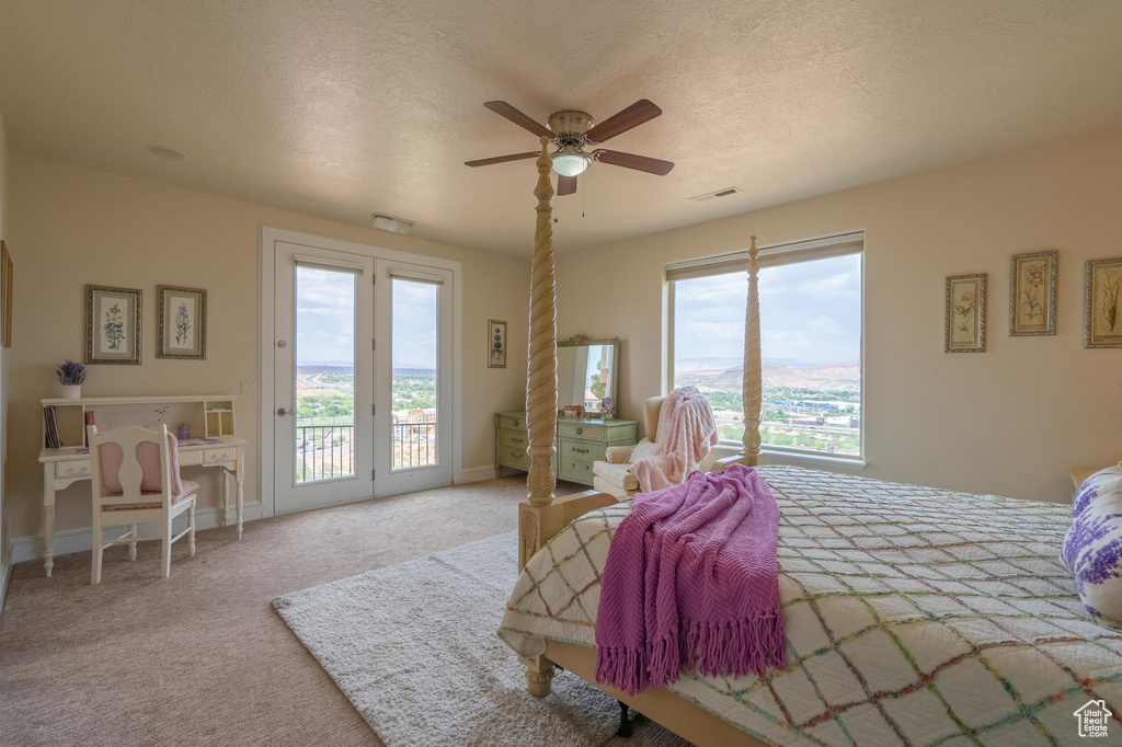 Bedroom with access to exterior, carpet flooring, ceiling fan, and a textured ceiling