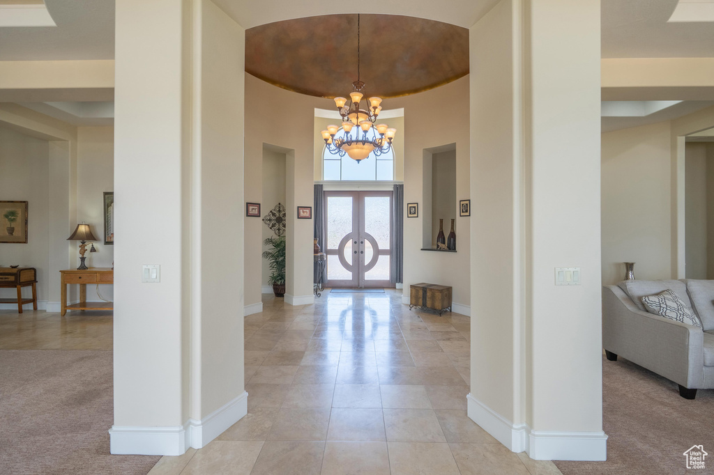 Entrance foyer featuring a chandelier and light tile patterned flooring