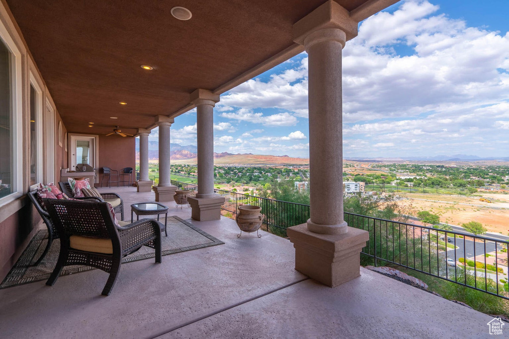 Patio / terrace with a ceiling fan and a mountain view