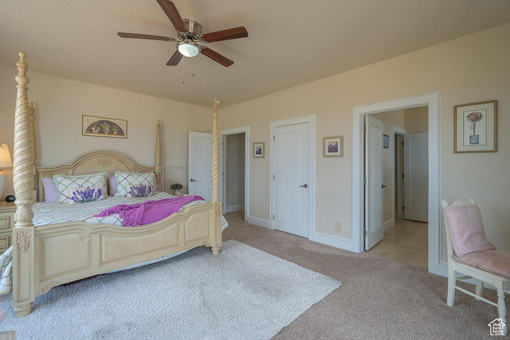 Bedroom featuring light colored carpet and a ceiling fan