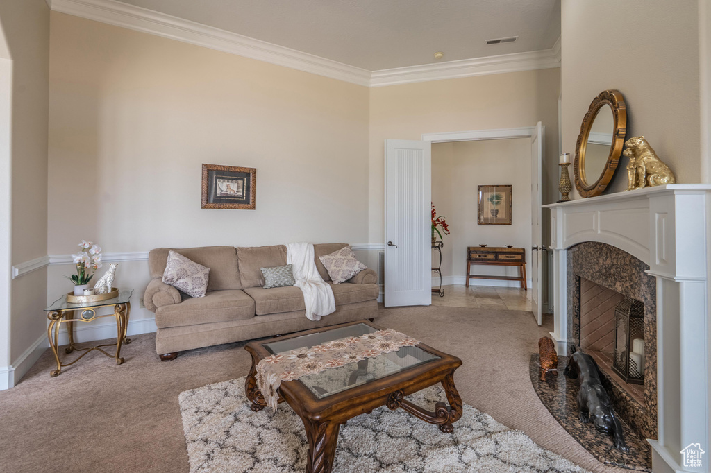 Living area with carpet, crown molding, and a premium fireplace