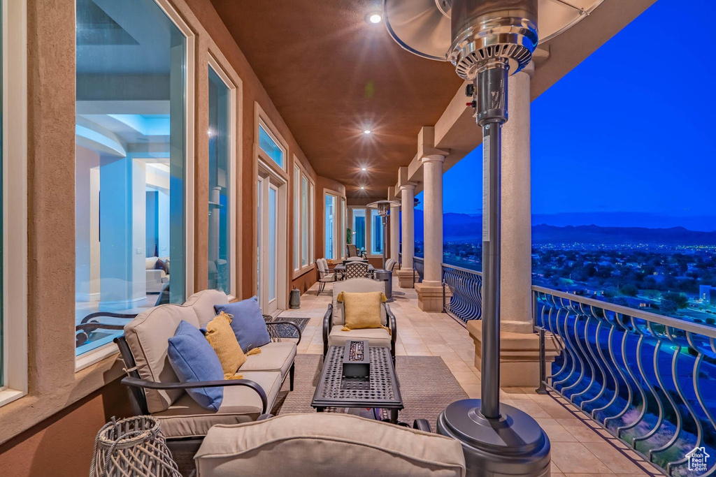 Patio at twilight with a balcony and an outdoor living space