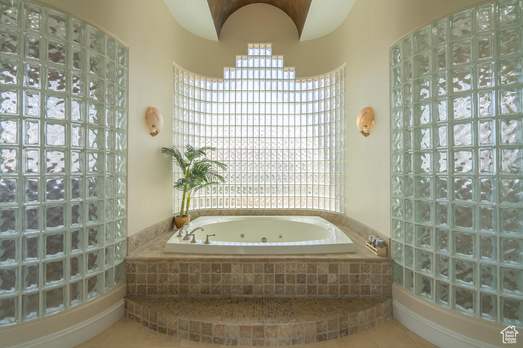 Full bathroom with a jetted tub and tile patterned floors