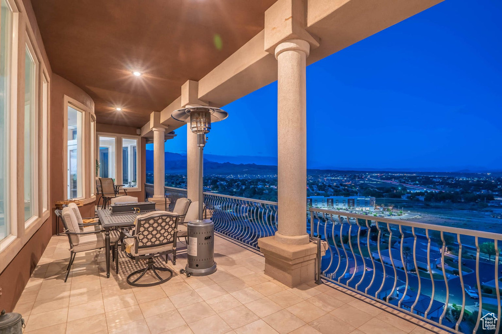 Balcony at night with outdoor dining area
