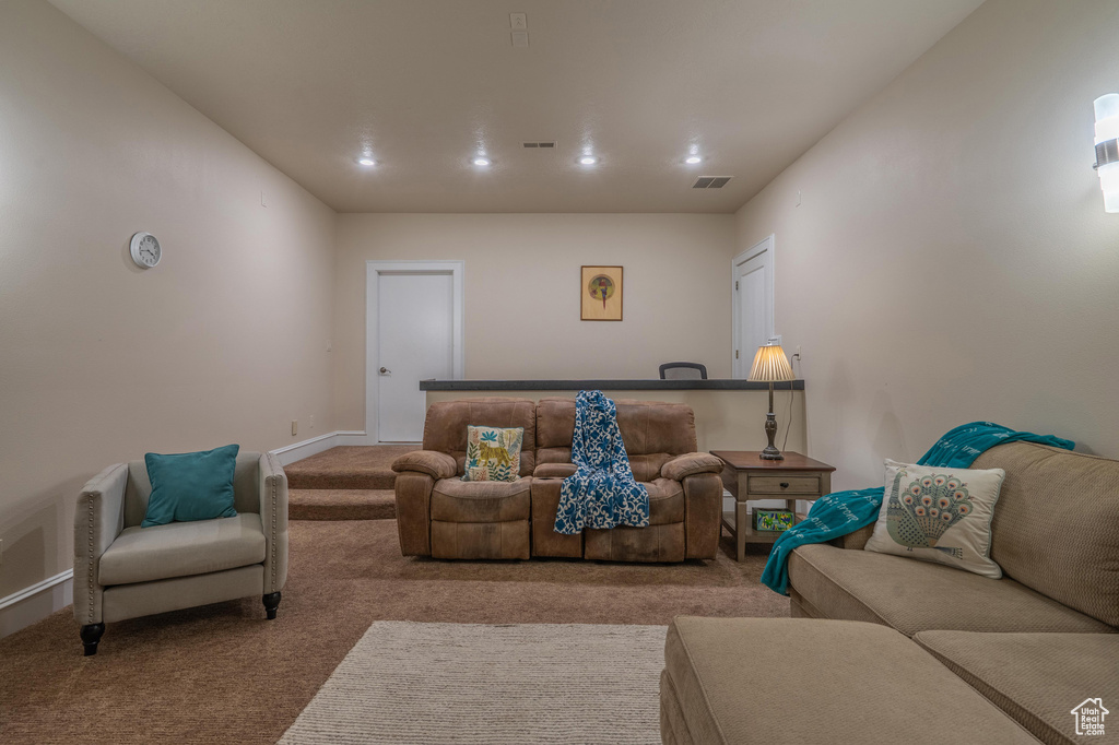Carpeted living area with baseboards