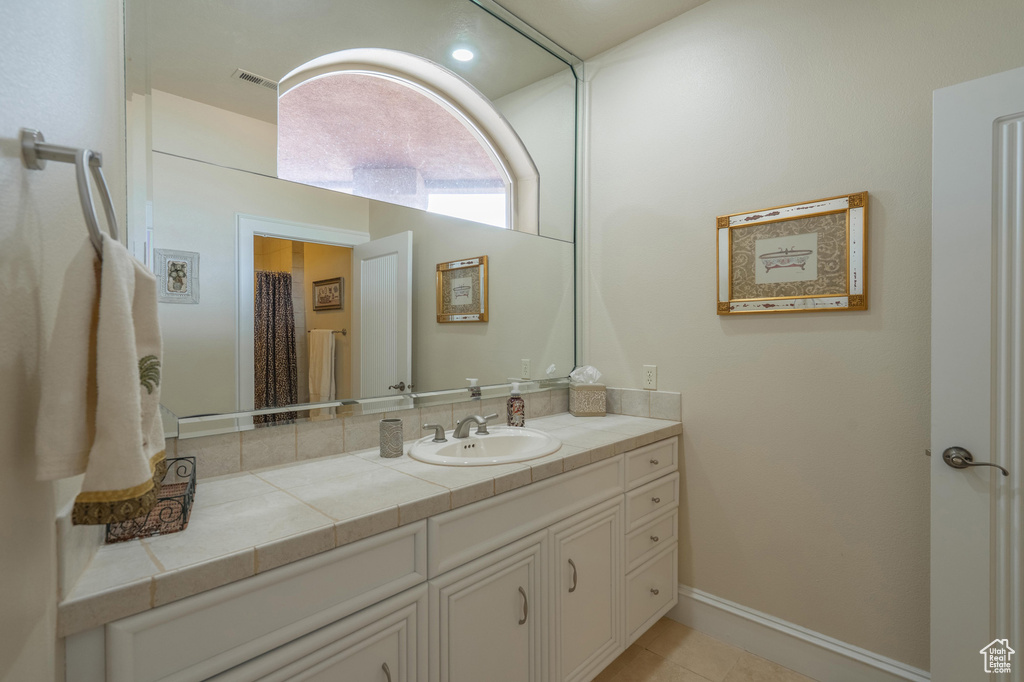 Full bathroom with vanity and tile patterned flooring