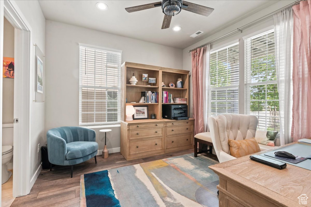 Office space with light wood-style flooring, ceiling fan, and recessed lighting