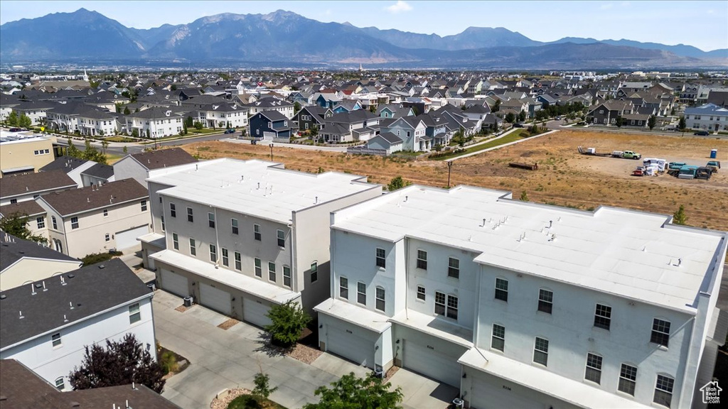 Aerial perspective of suburban area featuring a mountainous background