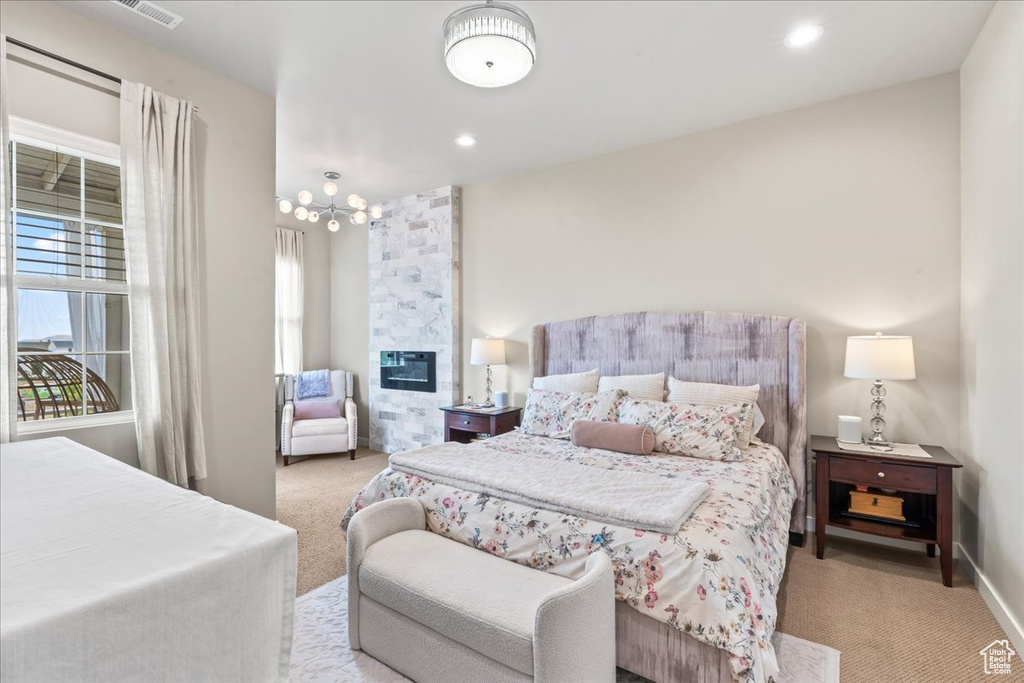 Bedroom with carpet floors, a large fireplace, and recessed lighting