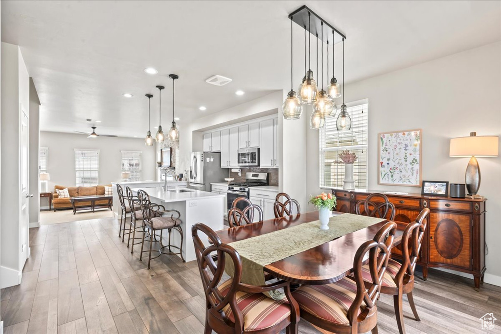 Dining area with light wood-type flooring, recessed lighting, and a ceiling fan