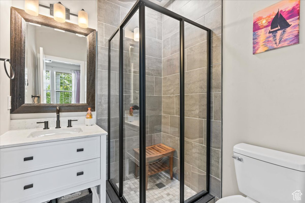 Bathroom featuring vanity and a stall shower