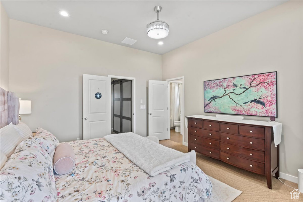 Bedroom with light carpet and baseboards
