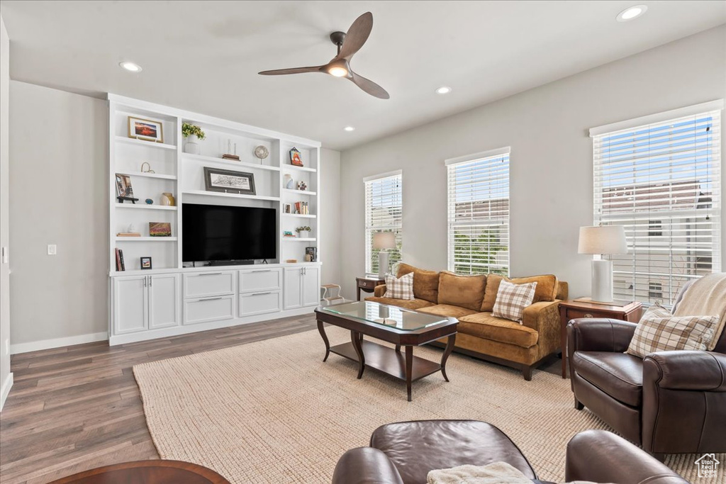 Living room with wood finished floors, ceiling fan, and recessed lighting