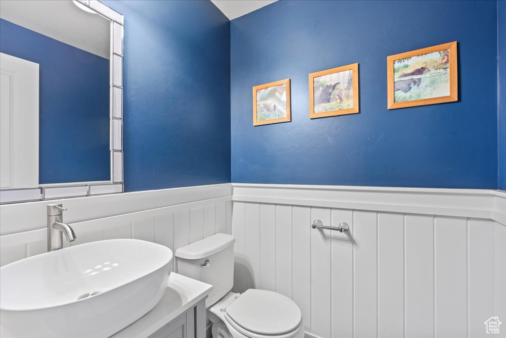 Bathroom with a wainscoted wall and vanity