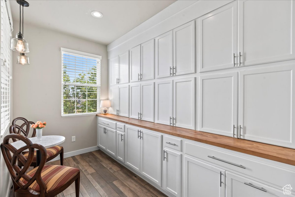 Living area with recessed lighting and dark wood-style floors
