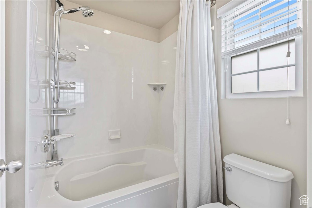 Bathroom with shower / bath combination with curtain