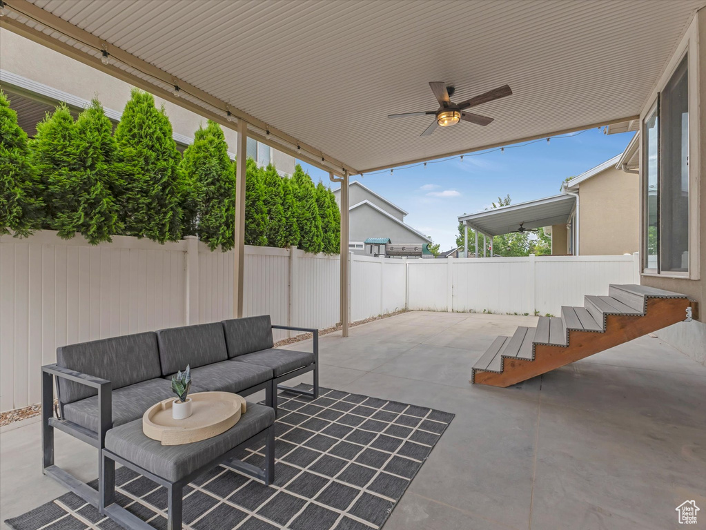View of patio featuring outdoor lounge area and a ceiling fan
