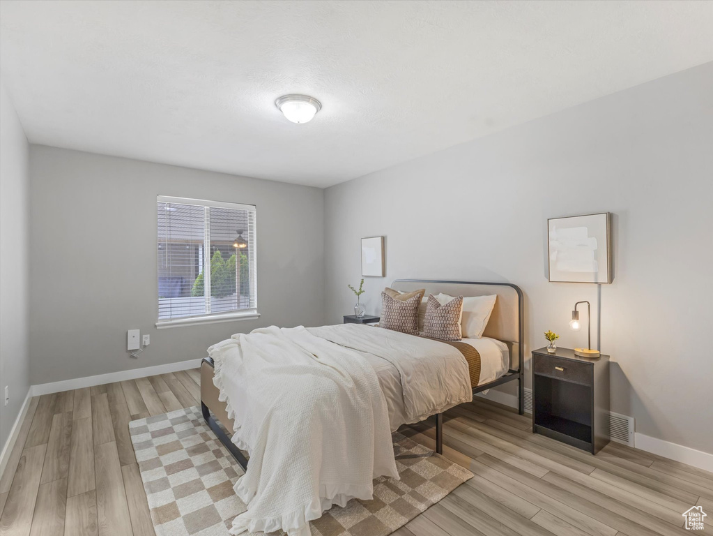 Bedroom with light wood-style floors