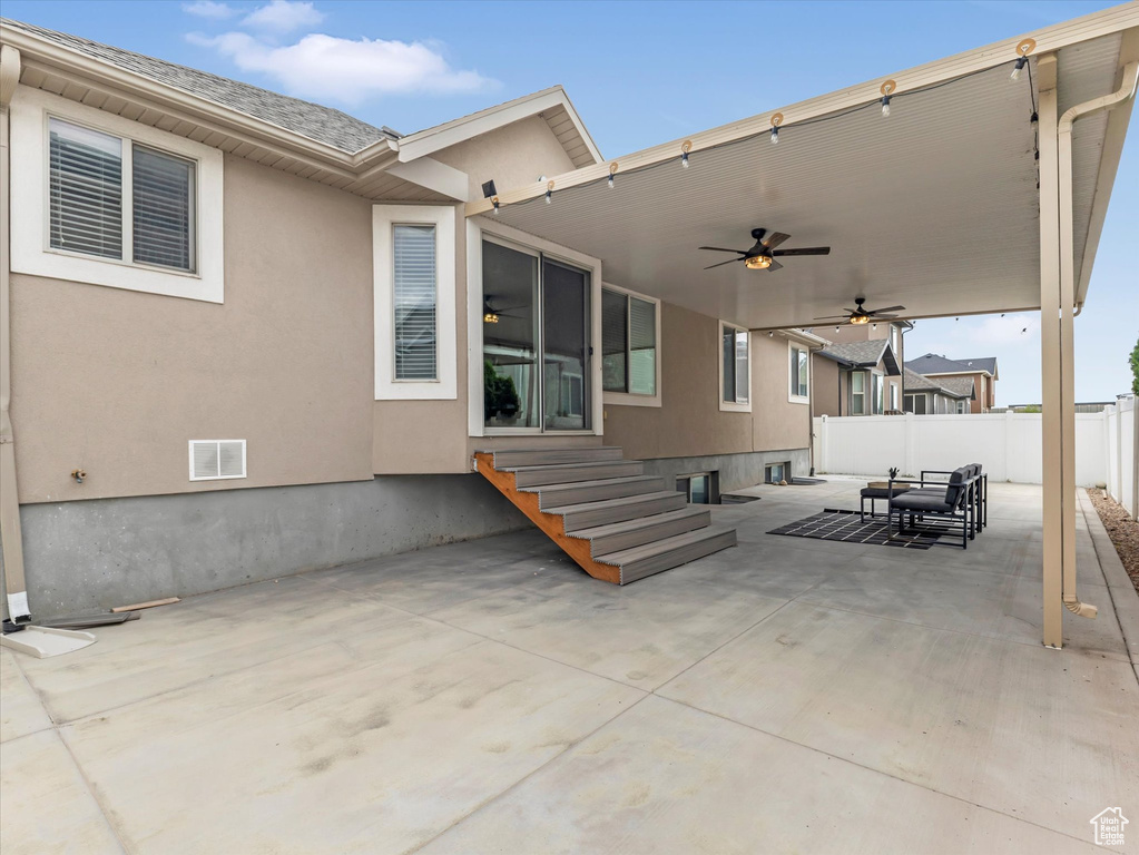 View of patio featuring a ceiling fan and entry steps