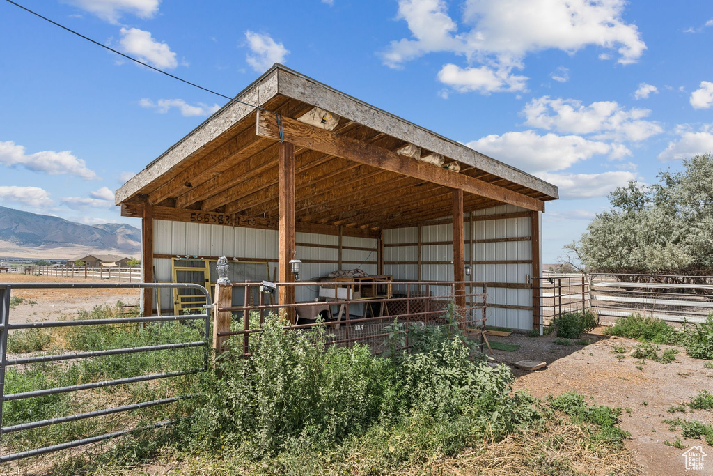 View of outdoor structure featuring an exterior structure, a mountain view, and a detached carport