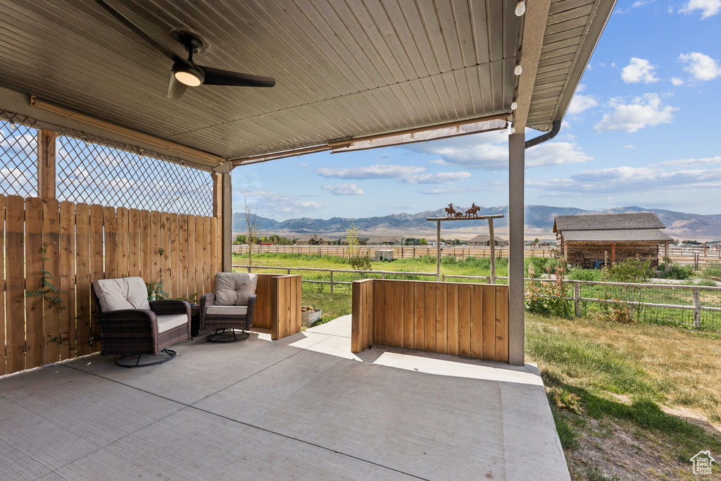 View of patio featuring a mountain view, a view of rural / pastoral area, and ceiling fan