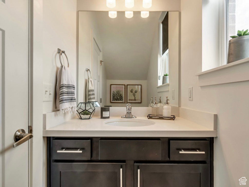 Bathroom with vanity and vaulted ceiling