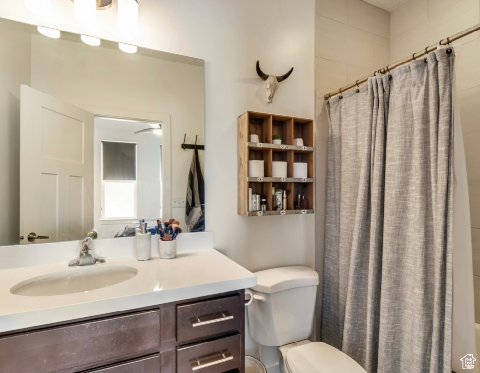 Full bath with vanity and a shower with shower curtain