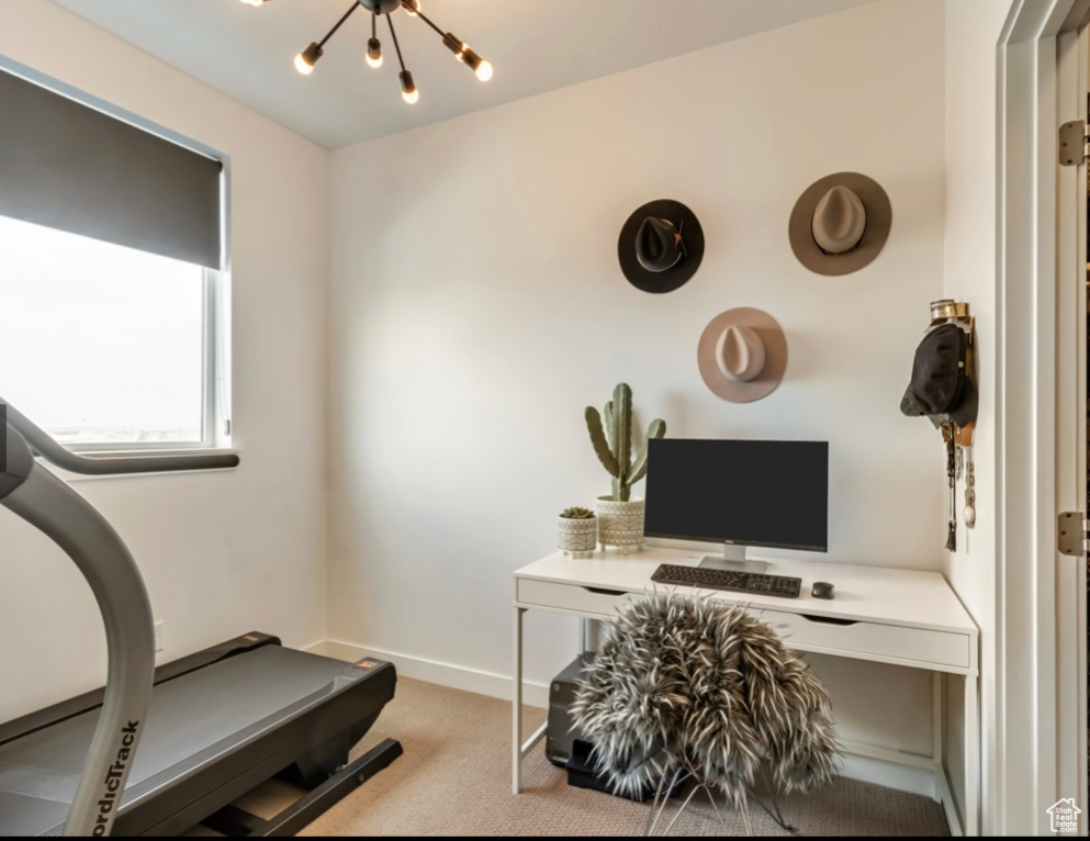 Office area featuring carpet flooring and a chandelier