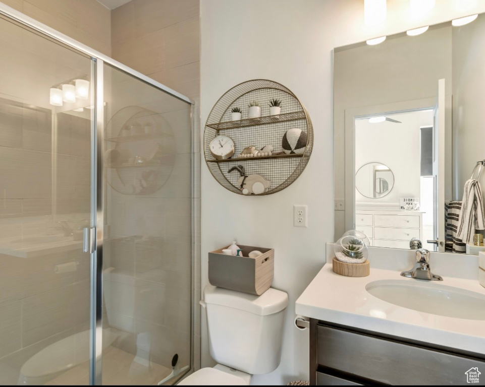 Bathroom featuring vanity and a shower stall