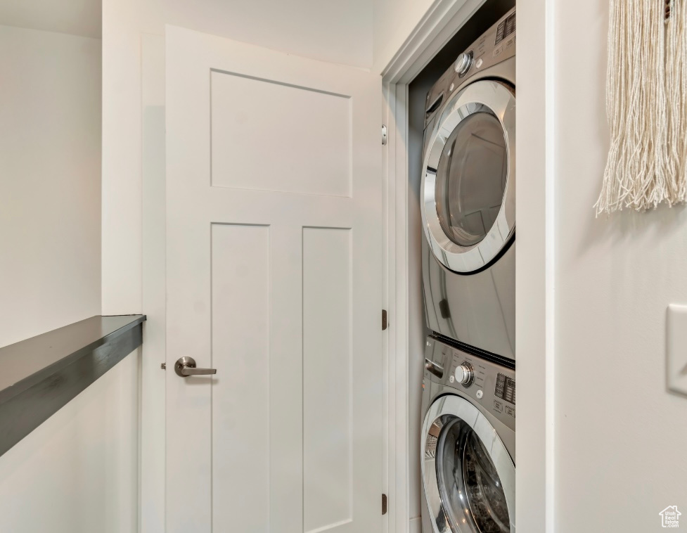 Washroom with stacked washer and clothes dryer