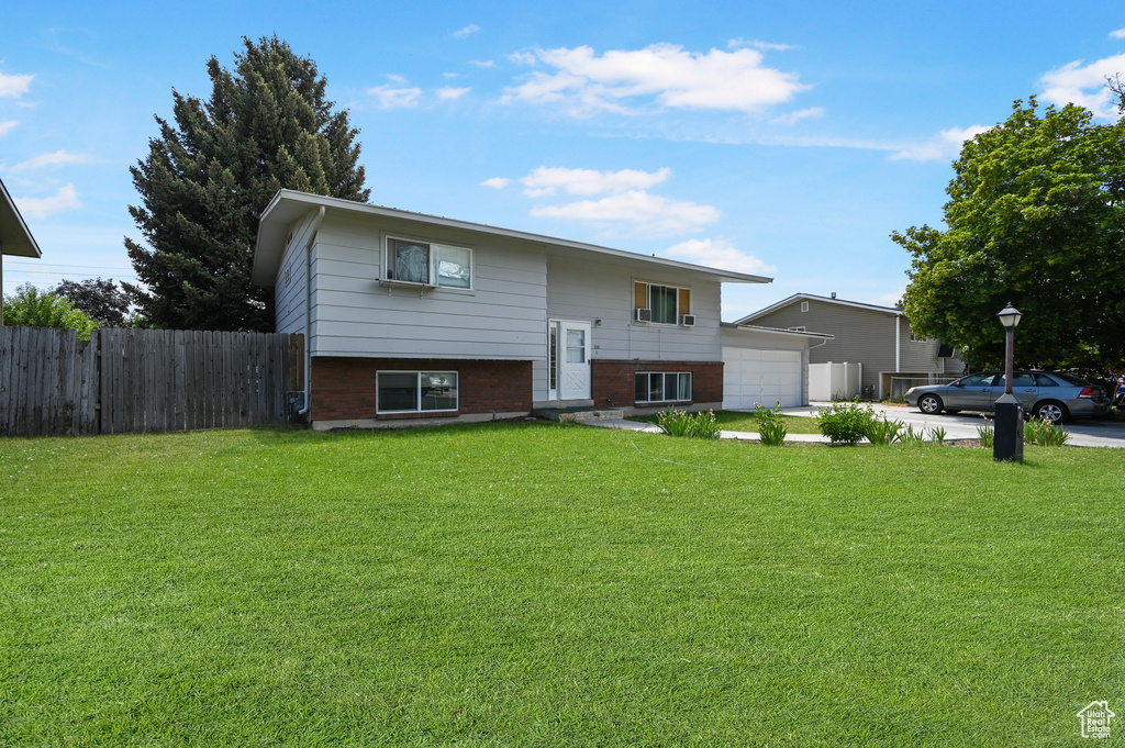 Split foyer home featuring an attached garage and concrete driveway