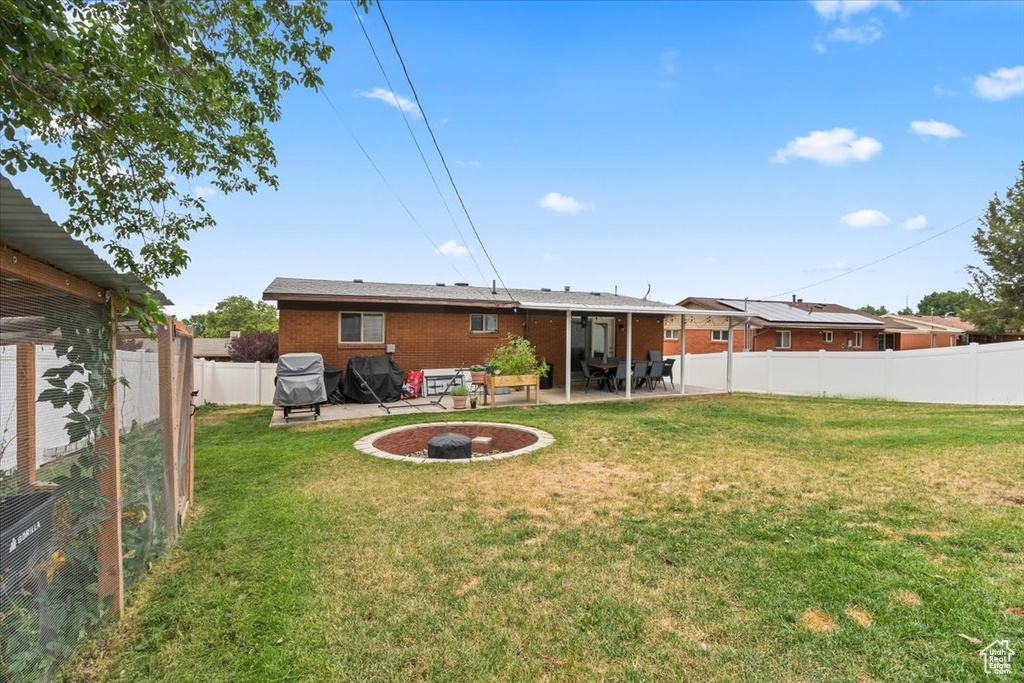 Back of house with brick siding, a patio area, and a fenced backyard