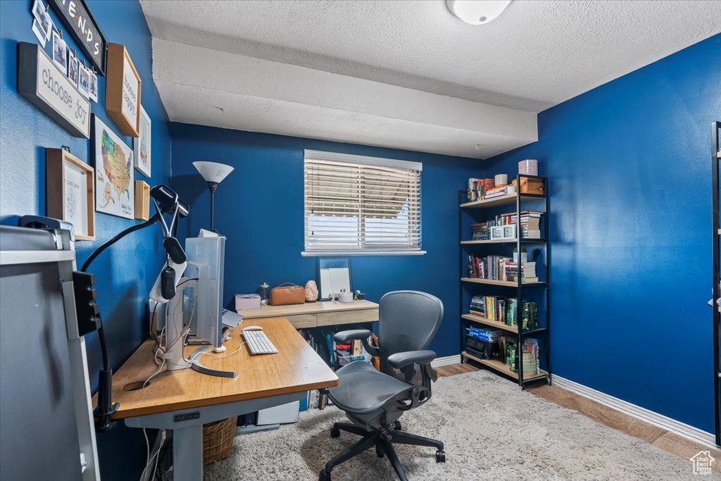 Office featuring a textured ceiling and baseboards