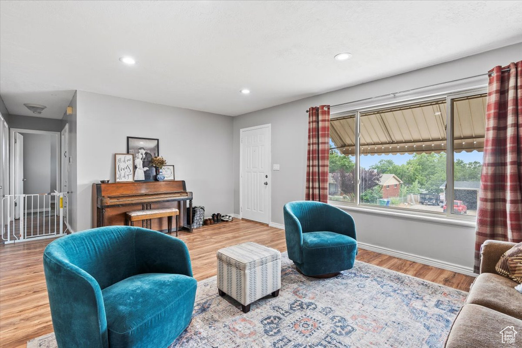 Living area with wood finished floors and recessed lighting