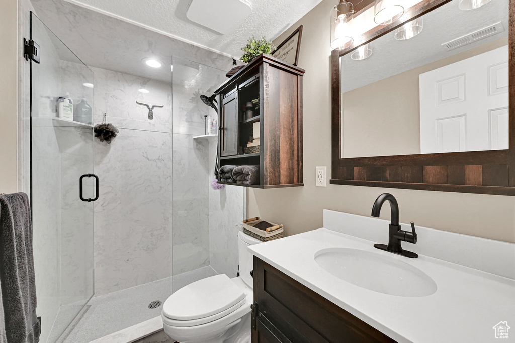 Bathroom with a stall shower and vanity