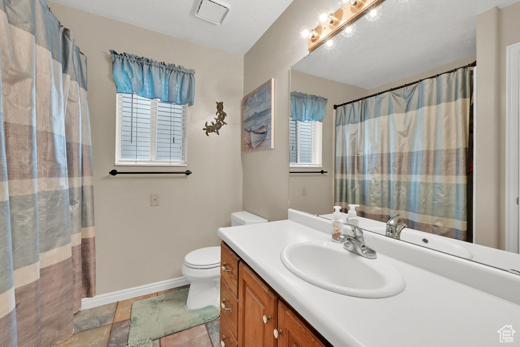 Full bath with vanity and toilet