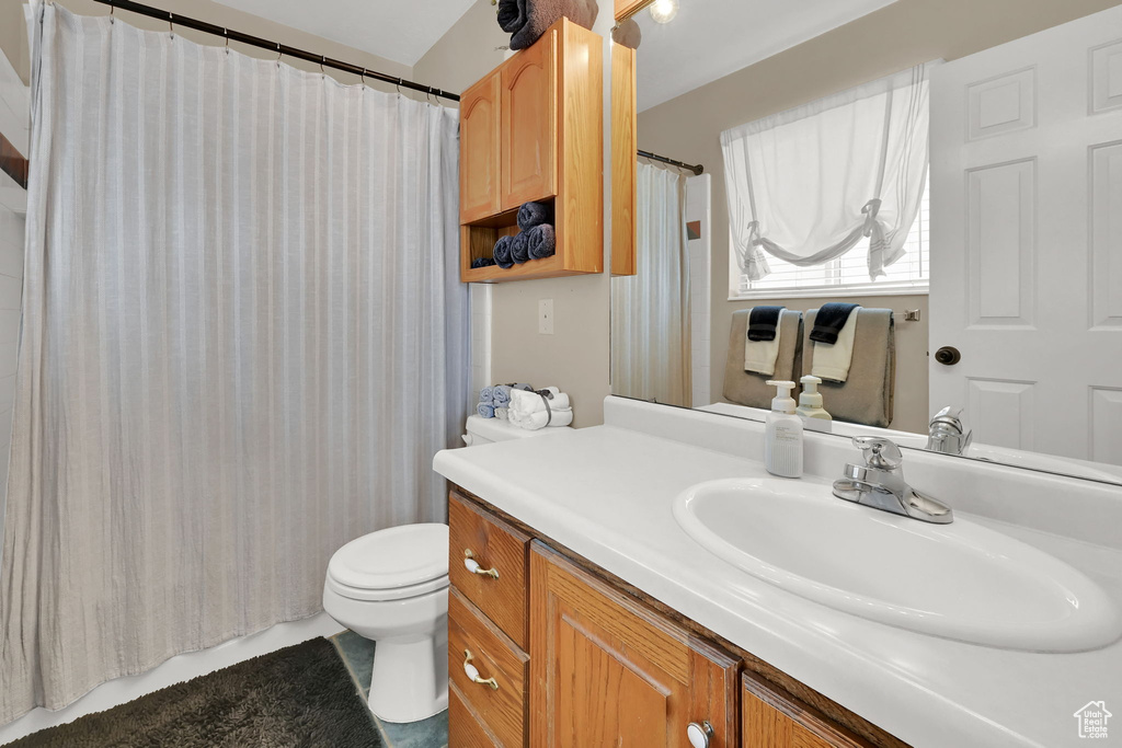 Bathroom with vanity and a shower with shower curtain