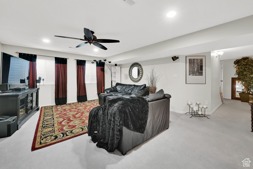 Living area with carpet, ceiling fan, and recessed lighting