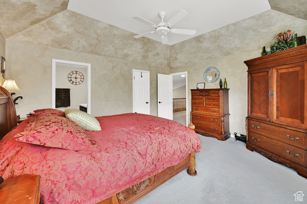 Bedroom with light carpet, lofted ceiling, and a ceiling fan