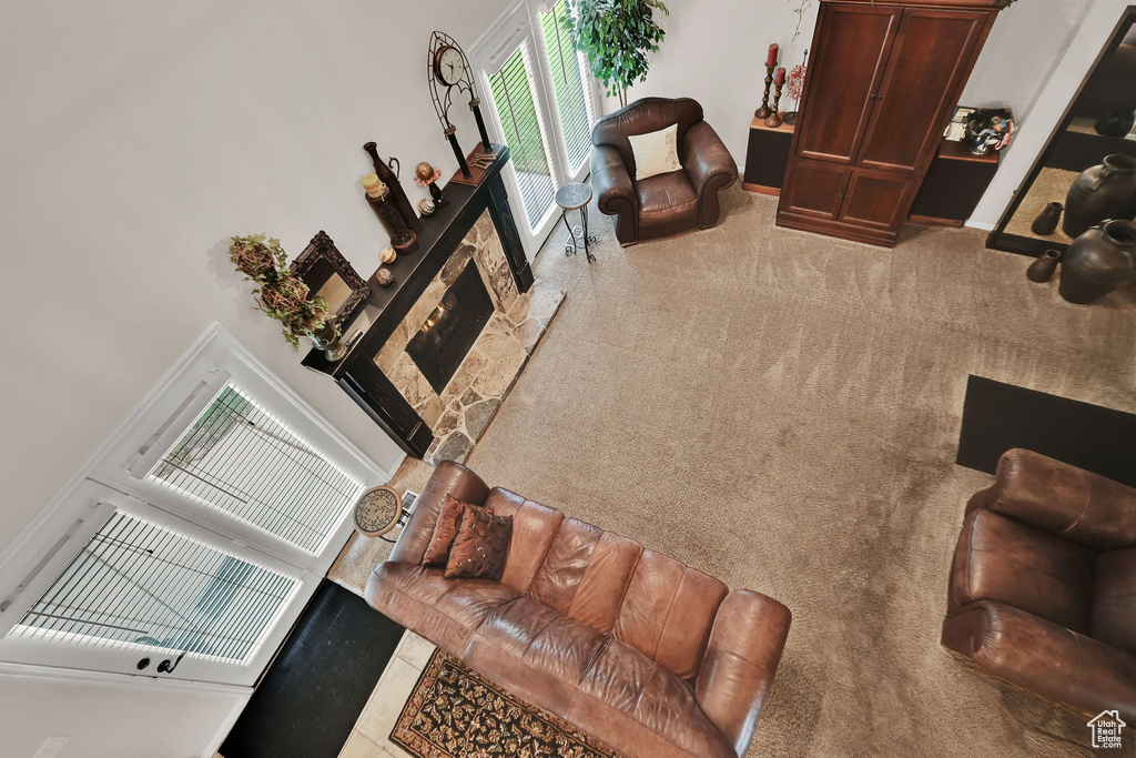 Living room with a towering ceiling and carpet flooring