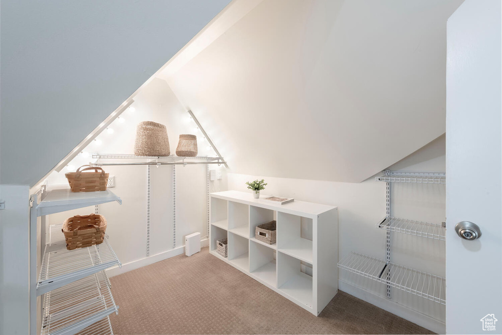 Additional living space with carpet floors and lofted ceiling