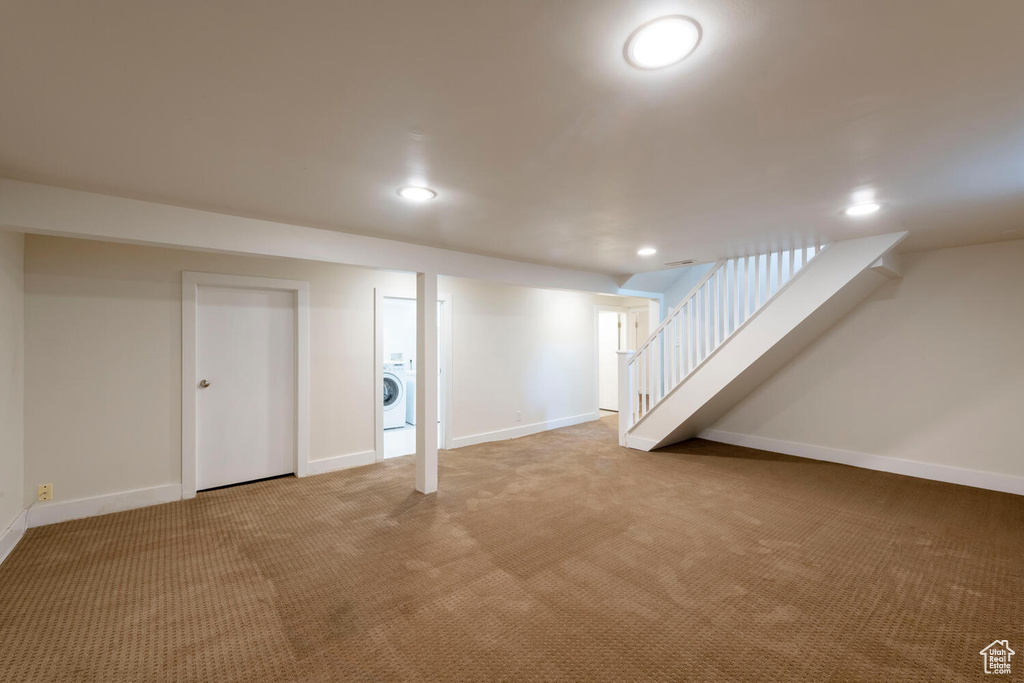 Finished below grade area featuring washer / clothes dryer, carpet, recessed lighting, and stairs