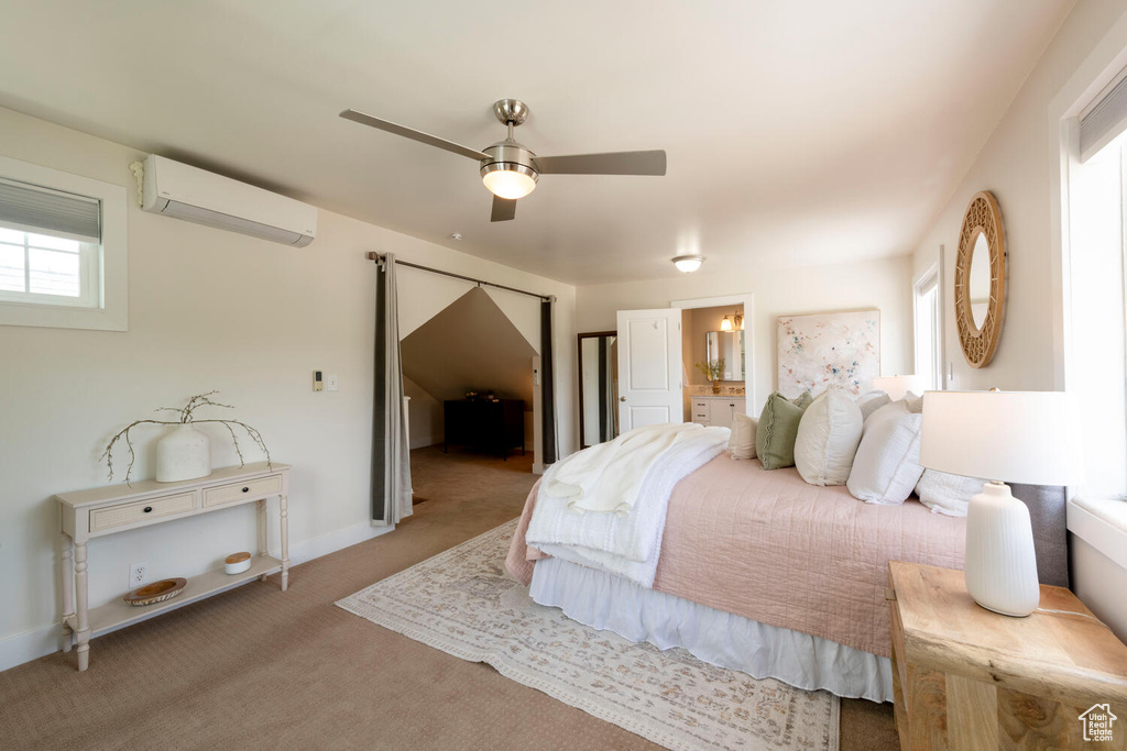 Carpeted bedroom featuring a wall mounted AC, connected bathroom, and a ceiling fan