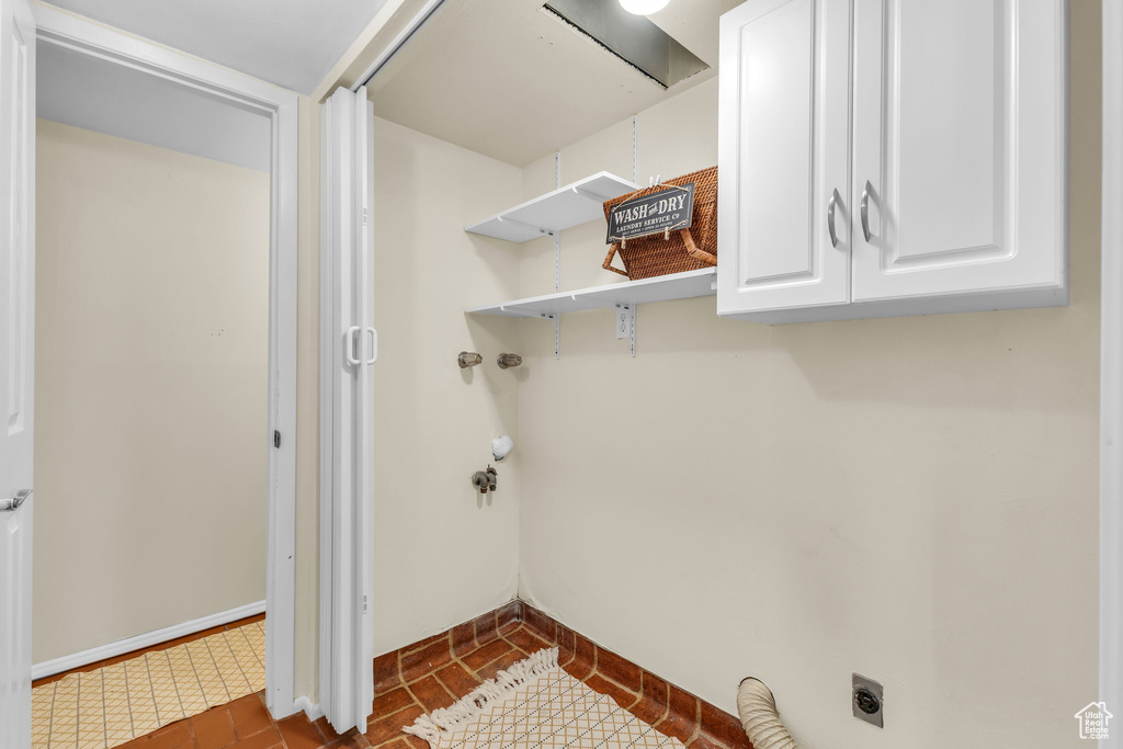 Laundry room featuring cabinet space and hookup for an electric dryer