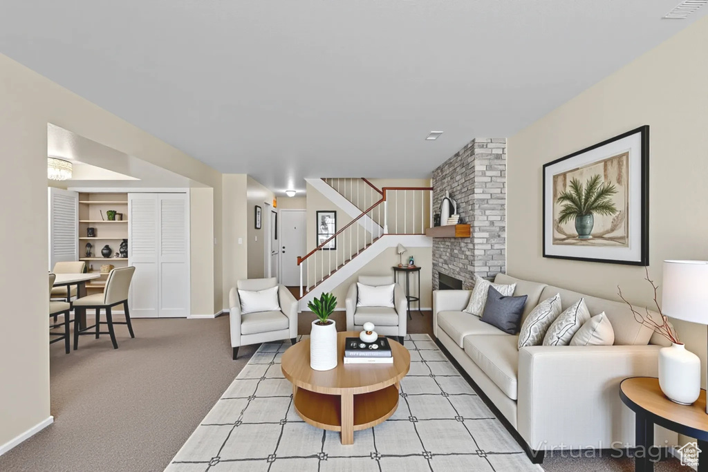Carpeted living area with stairway and baseboards