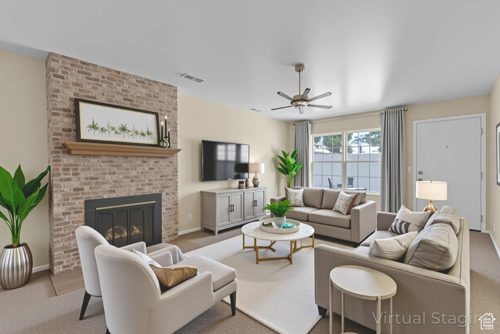 Carpeted living area with ceiling fan and a fireplace