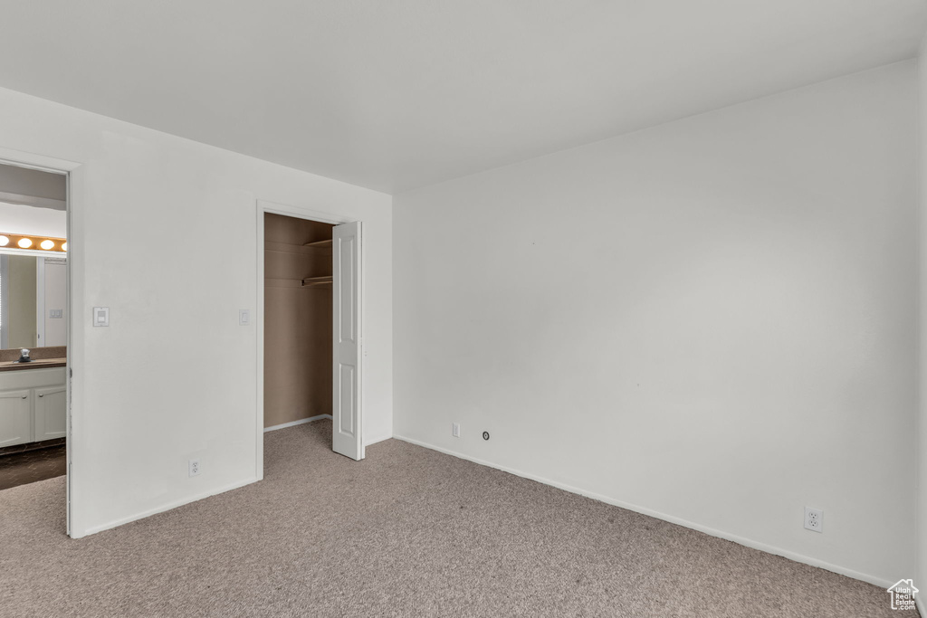 Unfurnished bedroom featuring carpet flooring and a closet