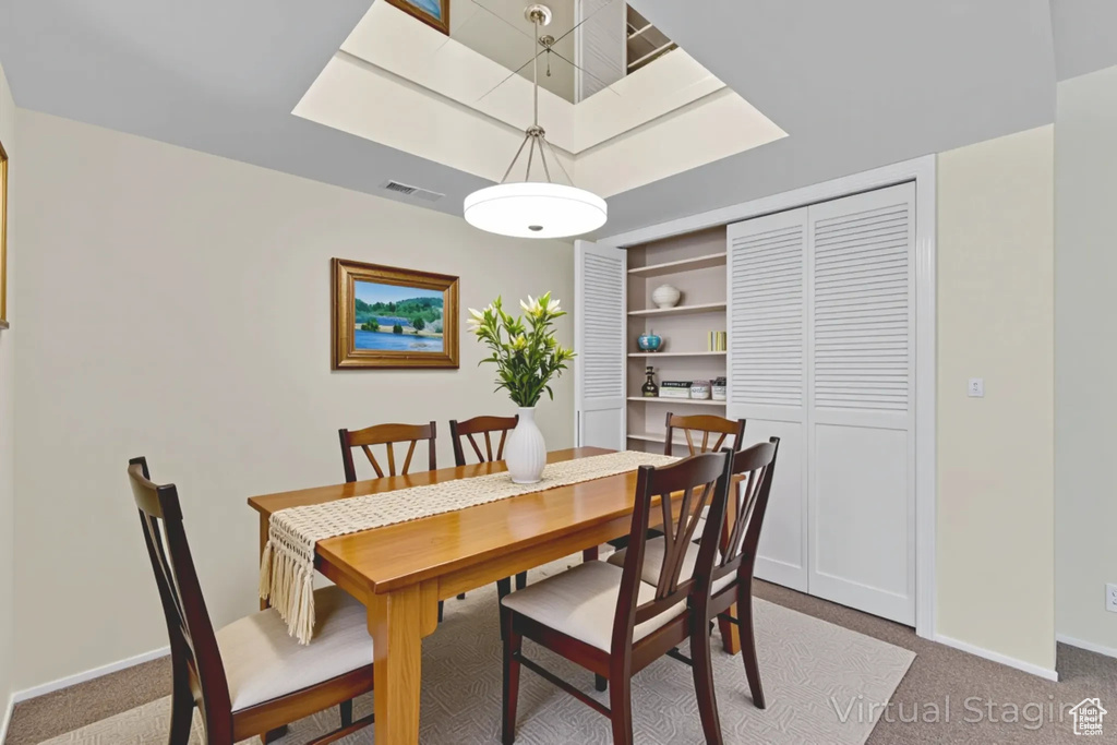 Dining area featuring carpet flooring and baseboards