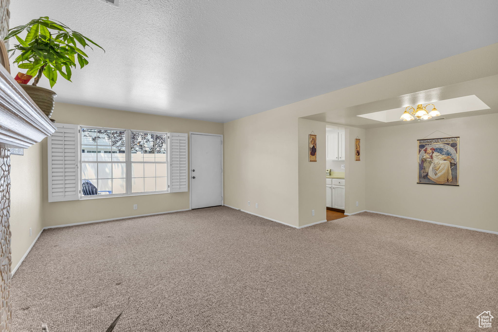 Unfurnished room featuring carpet and baseboards