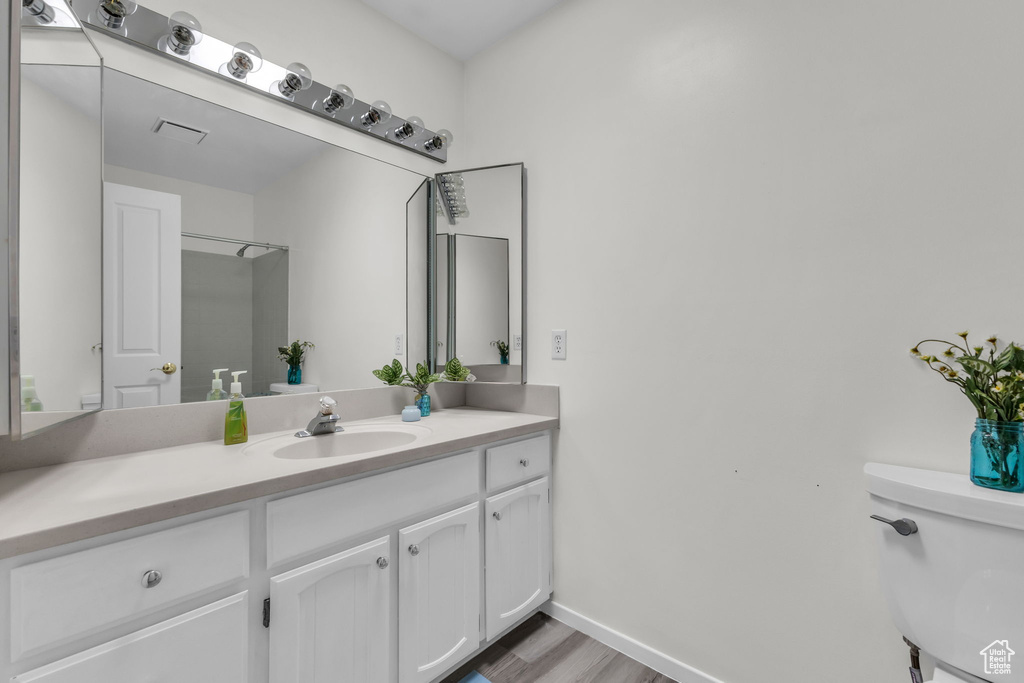 Bathroom with vanity and wood finished floors